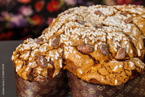 Tradizionale colomba pasquale ripiena di canditi e guarnita con granella di zucchero, pasta di mandorle e mandorle tostate photo