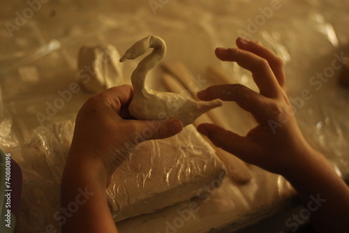 Child sculpts with plasticine