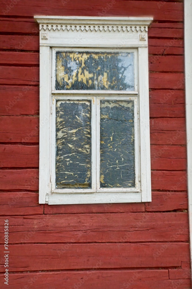 White framed window on old red painted wood wall.