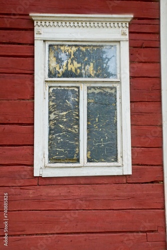 White framed window on old red painted wood wall.