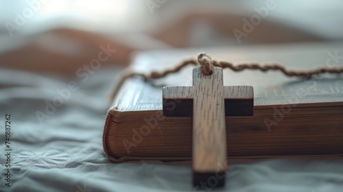 A wooden Catholic cross and a book lie on the bed. Happy Easter concept! 