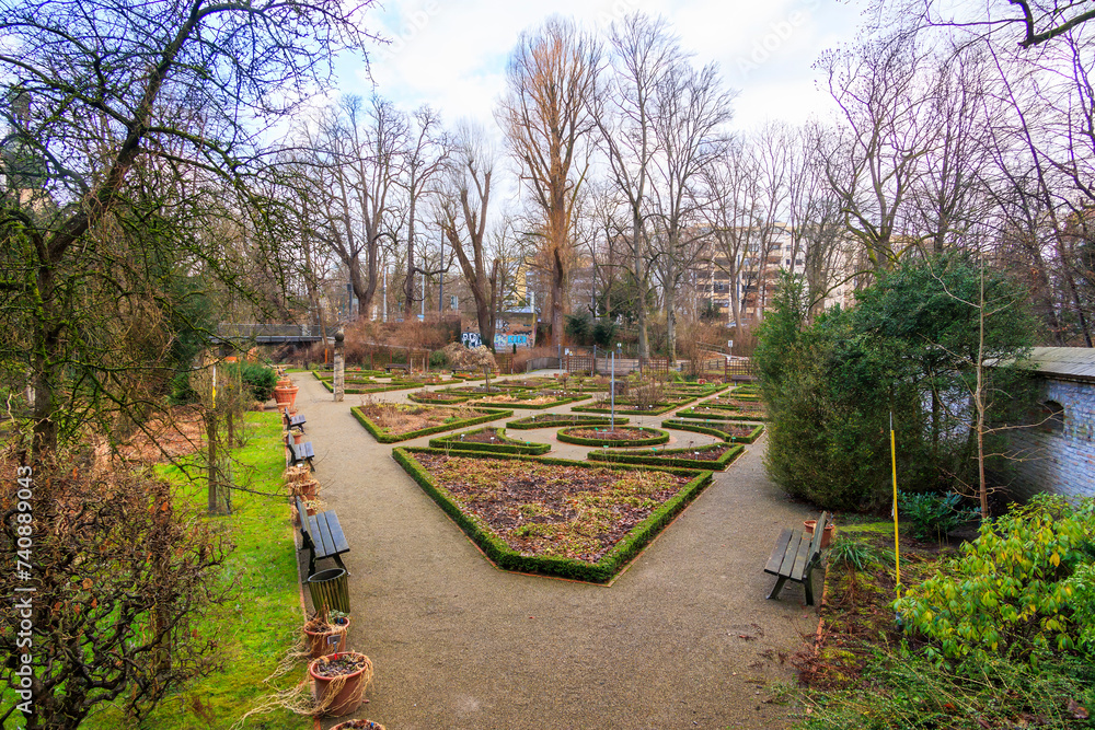Fototapeta premium The Augsburg herb garden at the foot of the.historic city wall and framed by imposing trees