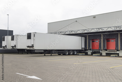 Row of red loading docks with containers of a warehouse or distbution center