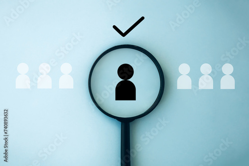 Human resources management concept. Employment headhunting. Recruiting with online technology. Magnifying glass focuses on manager icon, best candidate. Searching human to join the team 