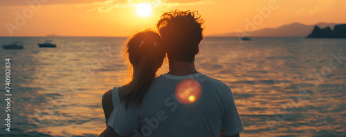 Back view of Caucasian couple at the beach during sunset