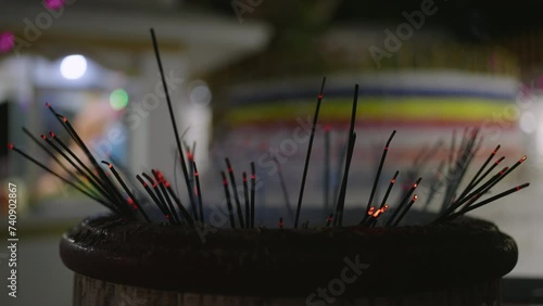 Close-up of glowing incense sticks in temple. Faithful incense for prayer, worship, fill air with sacred aroma. Tranquil atmosphere, mindfulness in spiritual practice. Traditional asian devotion.