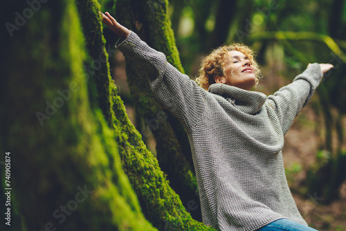 Happiness and nature wellbeing healthy people. One woman smile and enjoy freedom in outdoor leisure activity. Celebrating planet earth. Travel nature destination. Outstretching arms to breathe oxygen