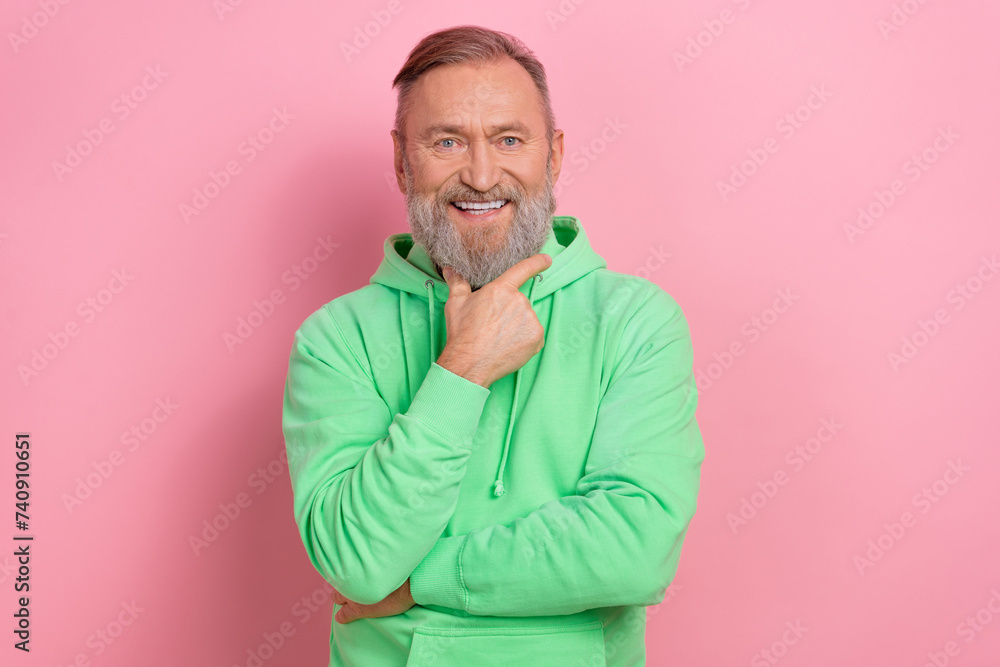 Photo of smart clever guy dressed green hoodie smiling hand arm chin isolated pink color background Photo of smart clever guy dressed green hoodie smiling hand arm chin isolated pink color background