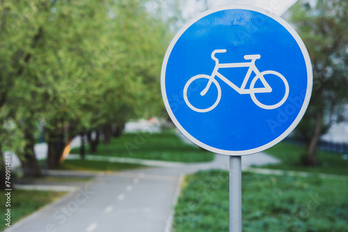 a blue circular bicycle sign at the bike path