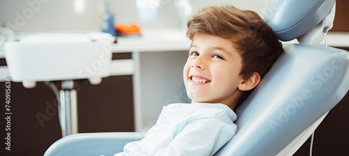A happy child is sitting in his dentist chair