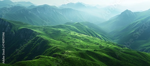 Serene mountain range with lush green hills under a clear blue sky landscape © TheWaterMeloonProjec
