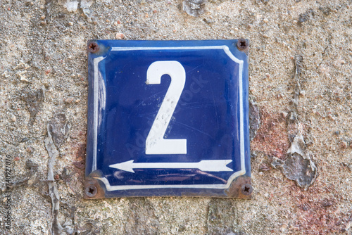 Weathered grunge square metal enameled plate of number of street address with number 2
