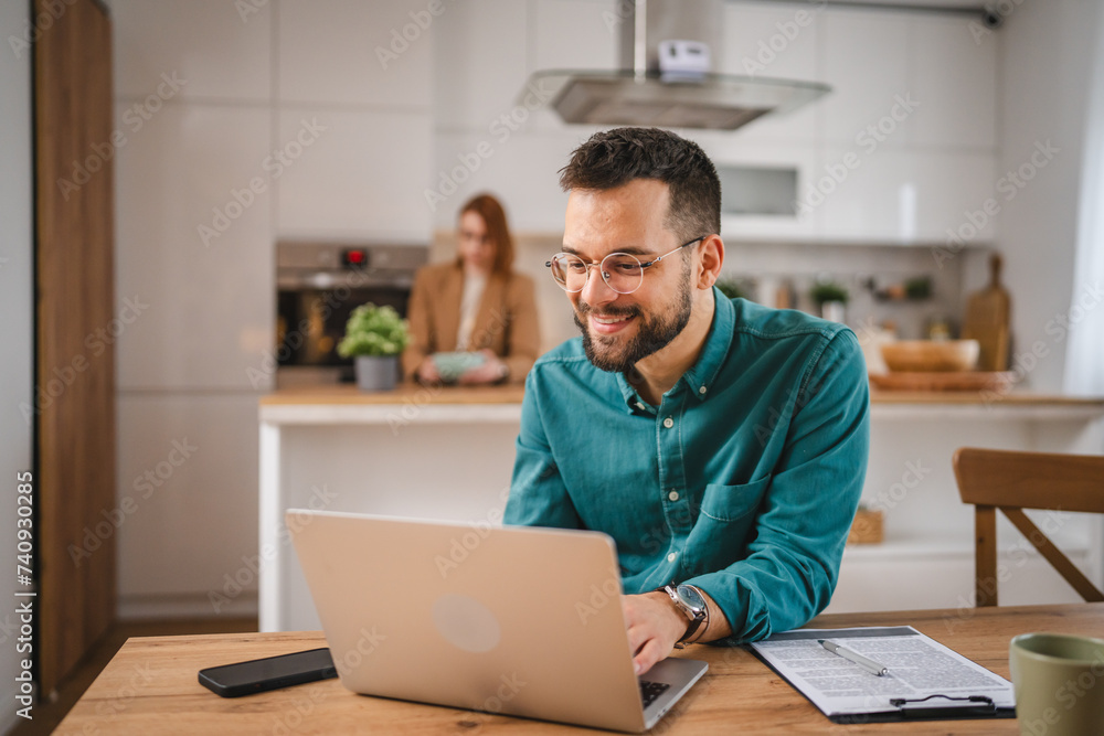 man adult caucasian WITH BEARD AND EYEGLASSES work on laptop at home man adult caucasian WITH BEARD AND EYEGLASSES work on laptop at home