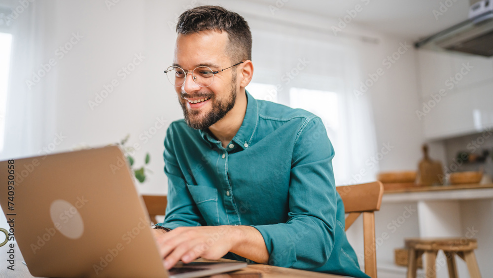 man adult caucasian WITH BEARD AND EYEGLASSES work on laptop at home man adult caucasian WITH BEARD AND EYEGLASSES work on laptop at home
