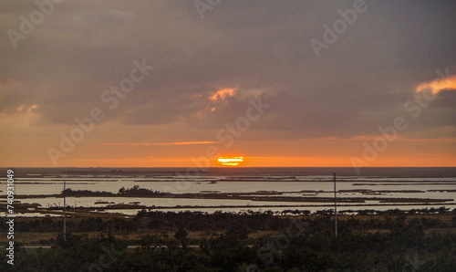 Idyllic scenic nature landscape scenery in Mississippi River delta with marsh, fisher boats, wildlife birds and animals, oil towers and horizon views