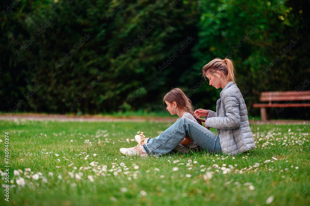 Tender moment between mother and daughter in a serene park setting Tender moment between mother and daughter in a serene park setting