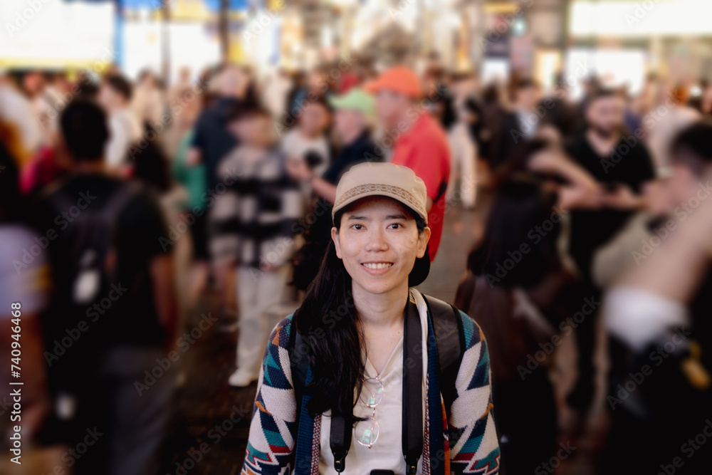 Asian woman friends shopping together at Shibuya district, Tokyo, Japan with crowd of people walking in the city. Attractive girl enjoy and fun outdoor lifestyle travel city in autumn holiday vacation
