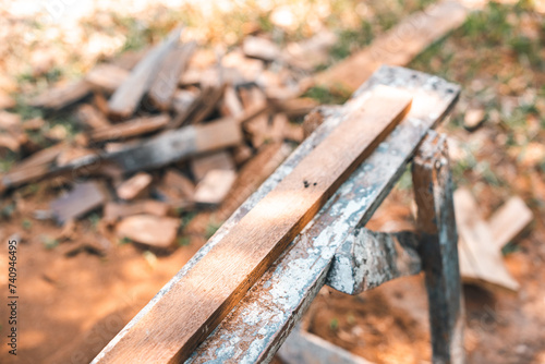 Background image of woodworking workshop: carpenters work table with different tools and wood cutting stand, vintage filter image