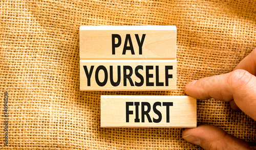 Pay yourself first symbol. Concept words Pay yourself first on beautiful wooden blocks. Beautiful canvas table canvas background. Businessman hand. Business and pay yourself first concept. Copy space.