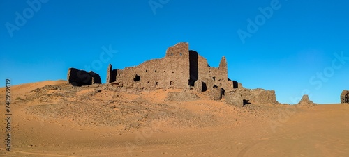 panoramic view of the remains of Ksour d'Aghlad, ruins of ancient castles made of stone and red clay in the middle of the desert in the town of Timimoun, Algeria
