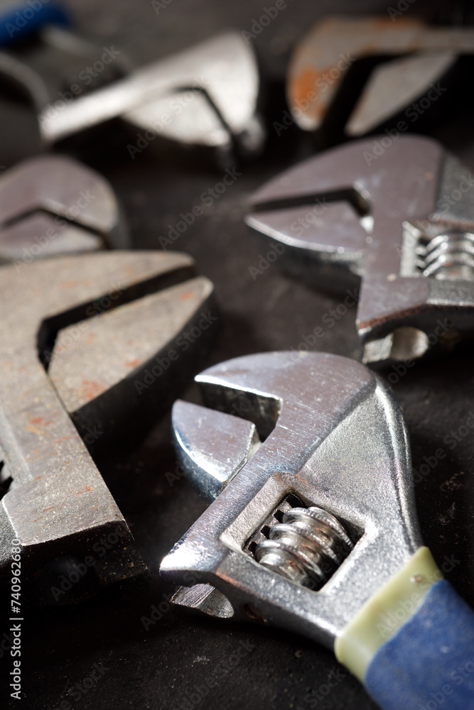 Wrenches of different sizes on a black table Wrenches of different sizes on a black table