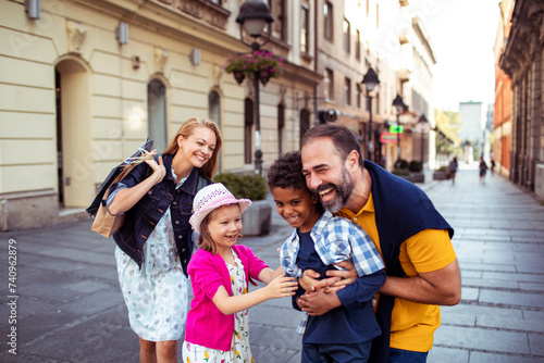 Joyful diverse family having fun on a city walk © Vorda Berge
