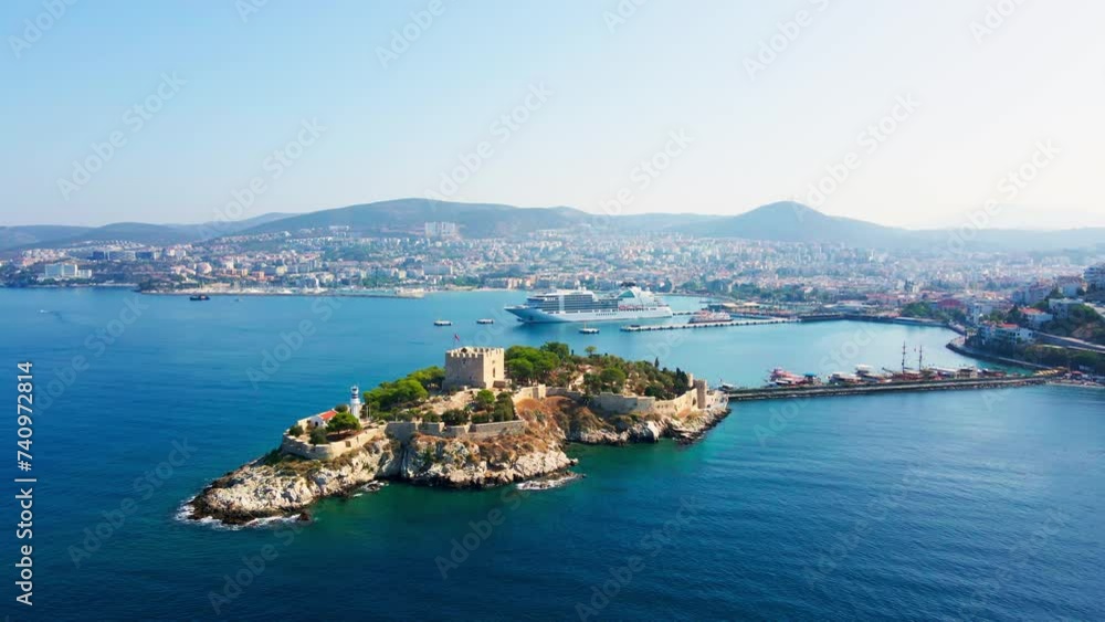 Aerial establishing shot of castle tower of Pigeon Island - Guvercinada in Kusadasi Turkey with cruise ship on background Aerial establishing shot of castle tower of Pigeon Island - Guvercinada in Kusadasi Turkey with cruise ship on background