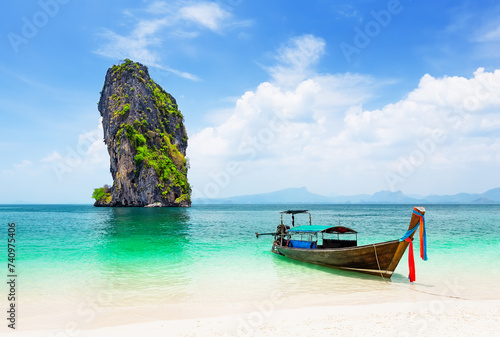 Thai traditional wooden longtail boat and beautiful sand beach at Koh Poda island in Krabi province, Thailand. © preto_perola