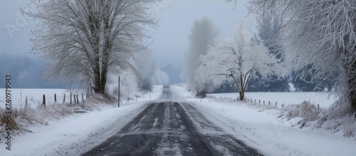 Scenic winter road with snow and trees in the background photo