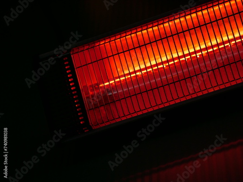 Infrared electrical heater on the wall in a street cafe. Warmth for visitors