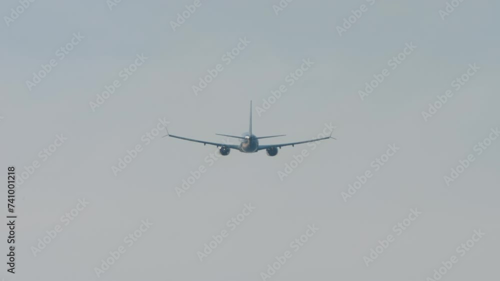 Rear view of a jet plane climbing after takeoff. The airliner leaving. Airplane silhouette in the sky Rear view of a jet plane climbing after takeoff. The airliner leaving. Airplane silhouette in the sky