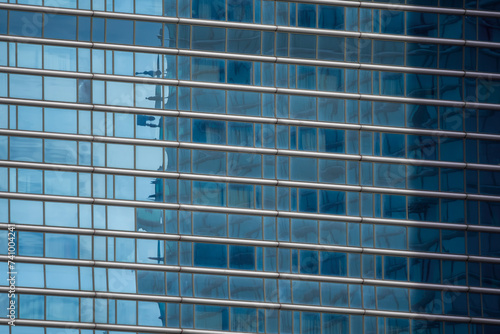 Architectural background. Fragment of building facade with blue glazing. Diagonal arrangement