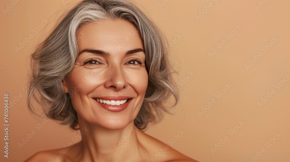 A joyful mature woman with a short stylish haircut expresses happiness, her shoulders bare and her smile infectious, embodying a youthful zest for life. A joyful mature woman with a short stylish haircut expresses happiness, her shoulders bare and her smile infectious, embodying a youthful zest for life.
