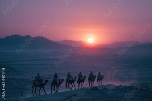 A caravan of camels walking in line on a desert dune under a vibrant sunset sky, leaving footprints in the sand.