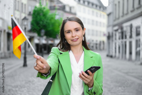 Young woman with flag of Ge...