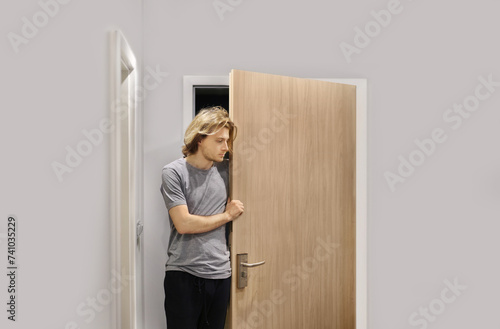 Man opening the door of his home.