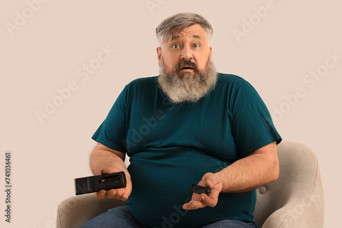 Shocked mature man holding ...