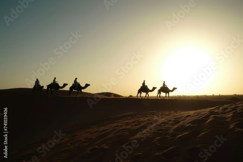 Silhouette people riding camels in desert native tuareg arabic african person Sahara wildlife tourist attraction Dubai arab tour sunset caravan adventure long journey tour dune sun Bible story Quran