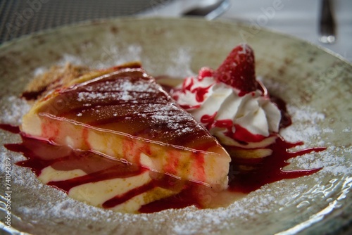 Handmade Cheesecake, dessert in a Restaurant decorated with Strawberries and whipped cream