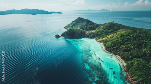 A tranquil island oasis, embraced by crystal clear waters and surrounded by lush tropics, beckons with its azure skies and majestic mountains rising from the coast photo
