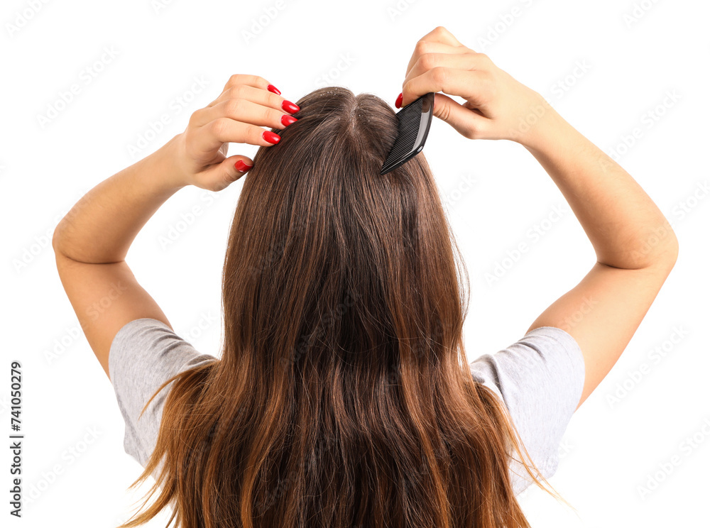 Fototapeta premium Young woman with dandruff combing hair on white background, back view