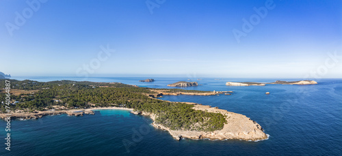 Cala Bassa beach and Cala Comte islets in Ibiza island aerial panorama