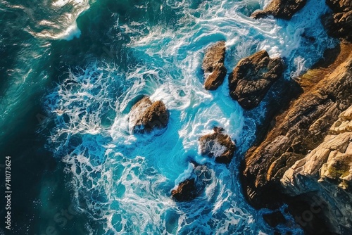 A breathtaking aerial snapshot of nature palette, where the sea many blues blend with the rocky browns of the coast.