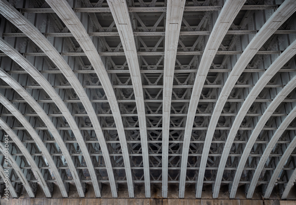 View of Structure and beams under the Curved steel Bridge. Framework metal arches girder construction Underneath of Blackfriars Bridge, Riveted steel beams supporting bridge span, Space for text, Sele