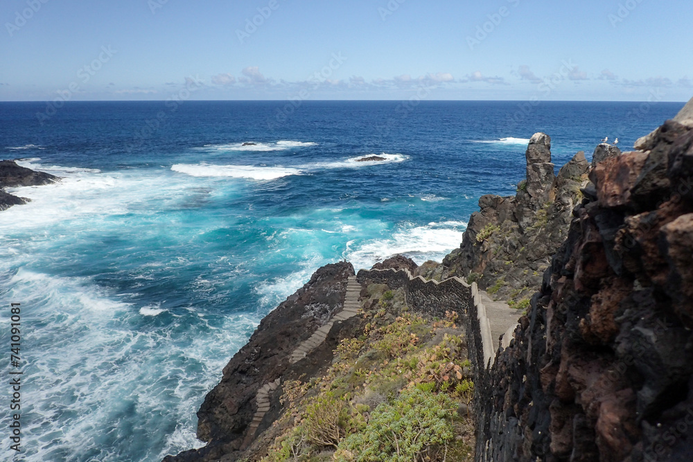 Buenavista del Norte, coastal panorama with path at the edge of the ocean Buenavista del Norte, coastal panorama with path at the edge of the ocean