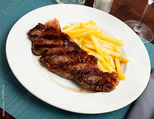 Tasty grilled beef tenderloin with french fries served at plate