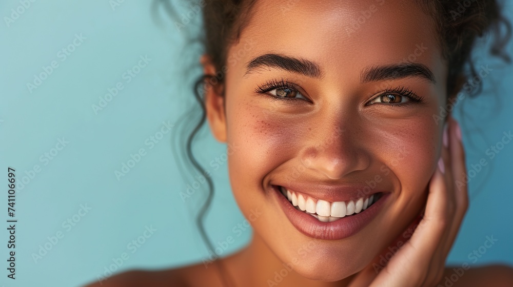 Portrait of happy satisfied woman with healthy smile isolated on blue background Portrait of happy satisfied woman with healthy smile isolated on blue background