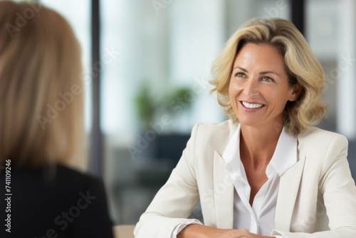 Mature professional female administrative manager happily having a job interview or business discussion