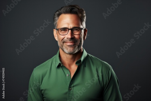 Happy smiling middle-aged businessman Confident professional businessman wearing colored shirt on gray background Advertising glasses lenses