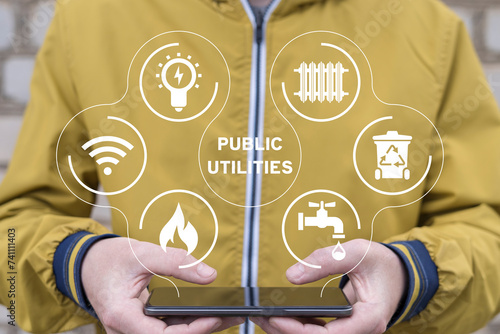 Foto Man holding phone, using virtual interface sees text: PUBLIC UTILITIES